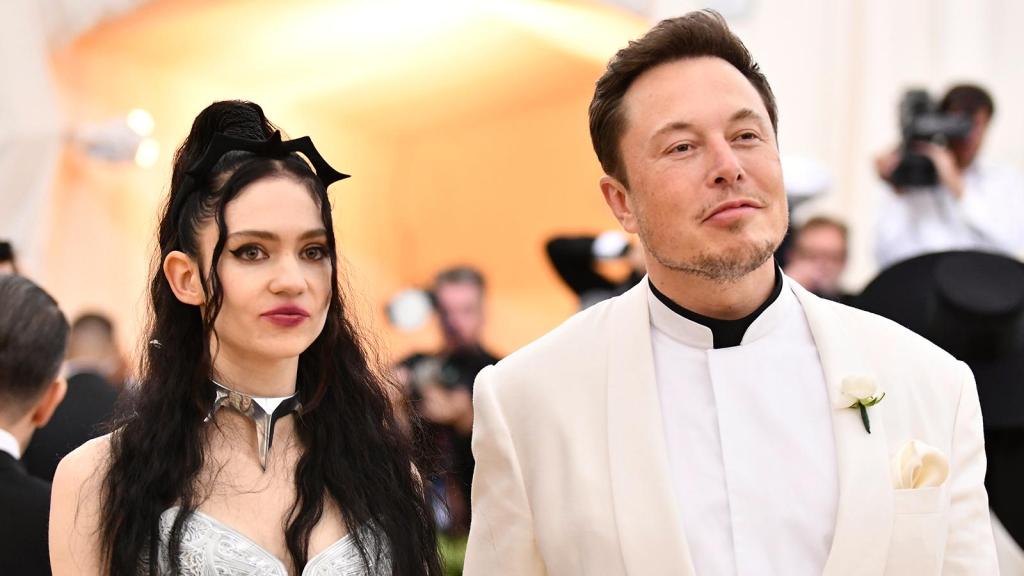 Elon Musk in white suit getting married to his pretty wife.